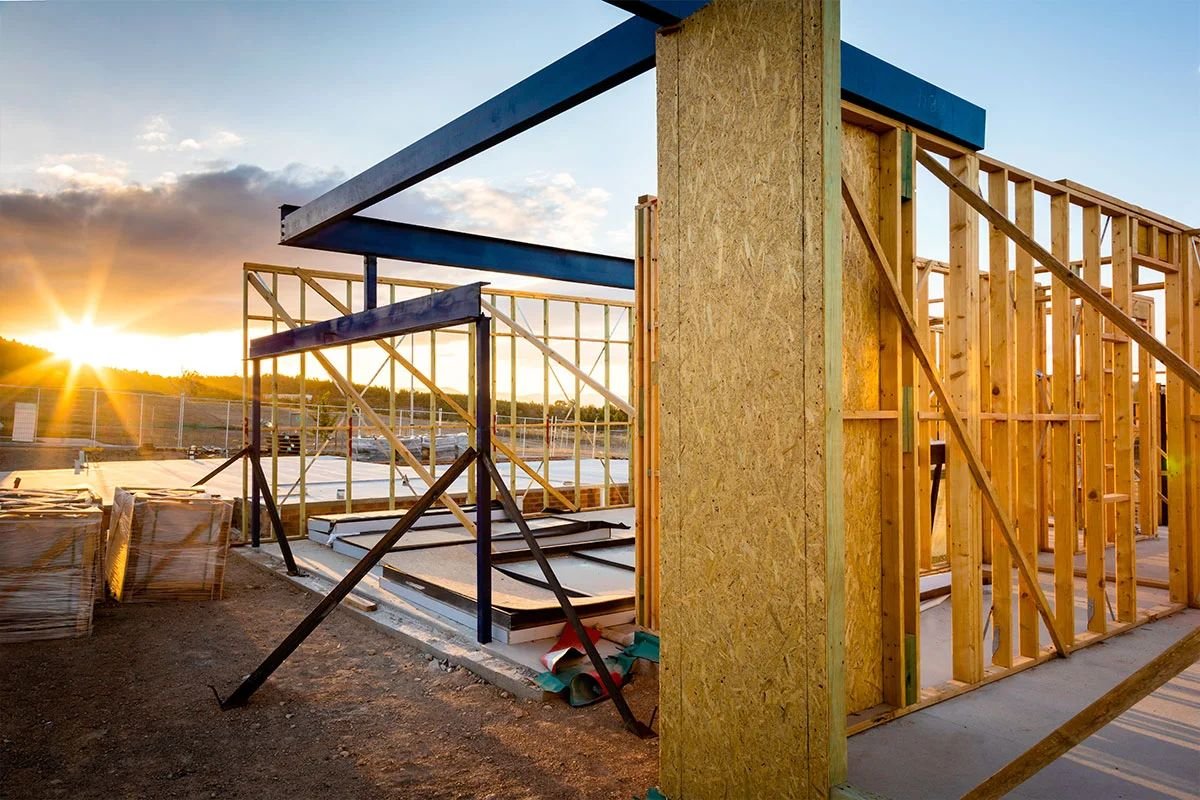 Steel beams and timber frame on a new build at sunset